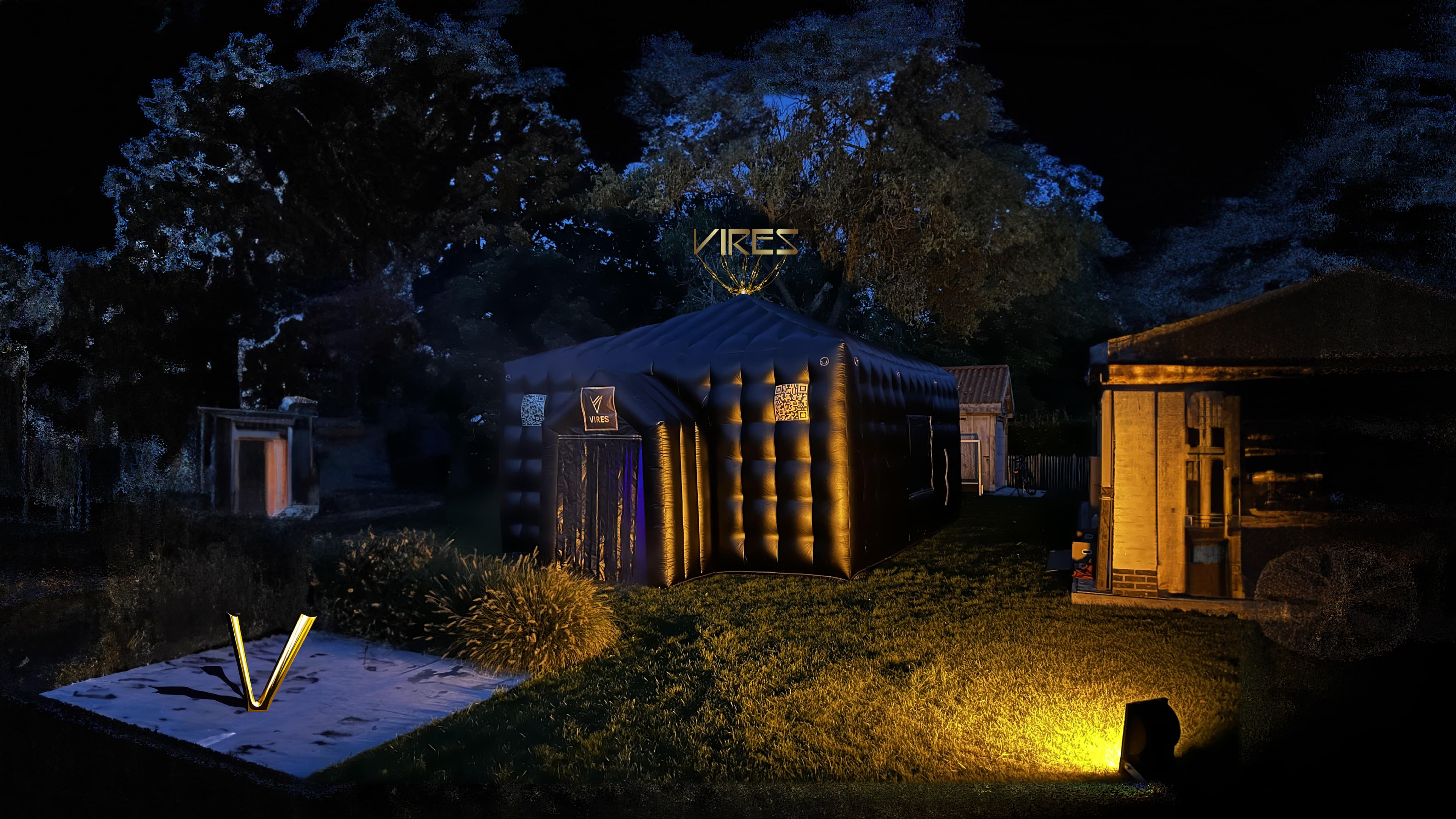 Picture of an inflatable black tent where you can party in a garden in the evening.